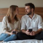 Ein Paar auf einem Hotelbett führt ein intimes Gespräch